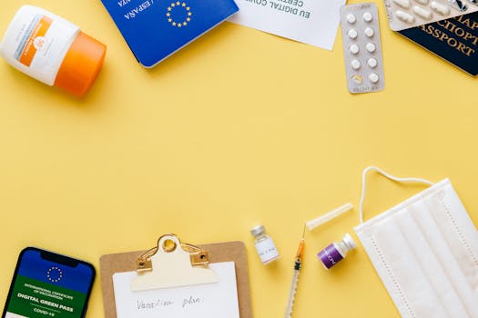 Flat lay of travel essentials including passport, mask, and vaccination pass.