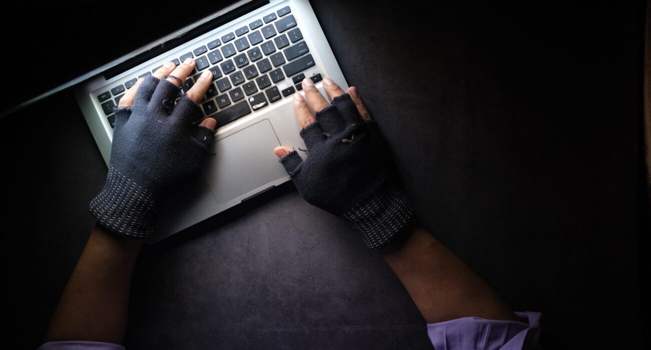 person in black long sleeve shirt using macbook pro