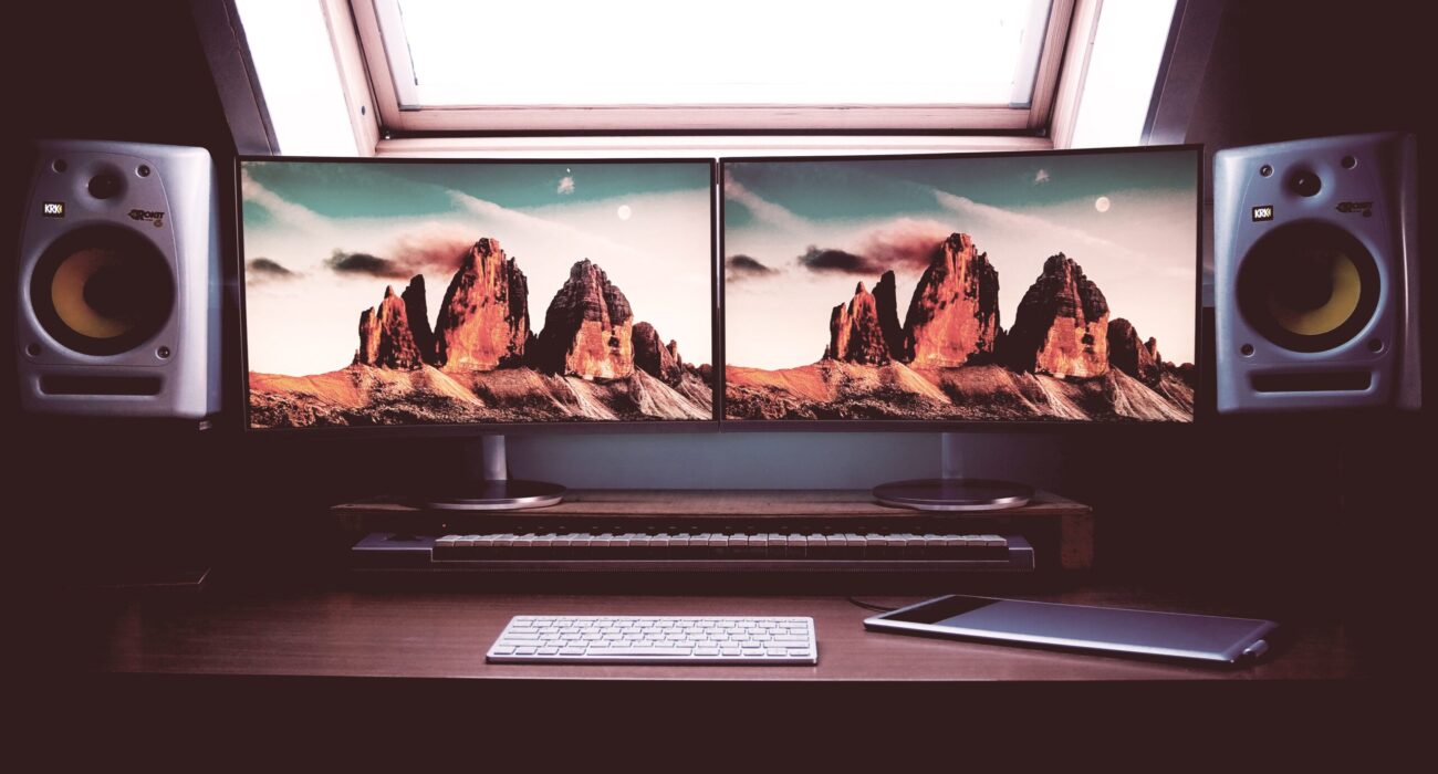 turned on two flat screen computer monitors with speakers