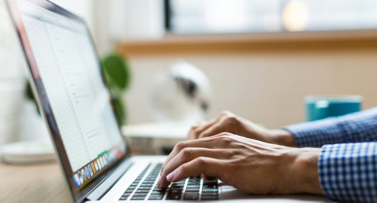 person typing on silver Macbook